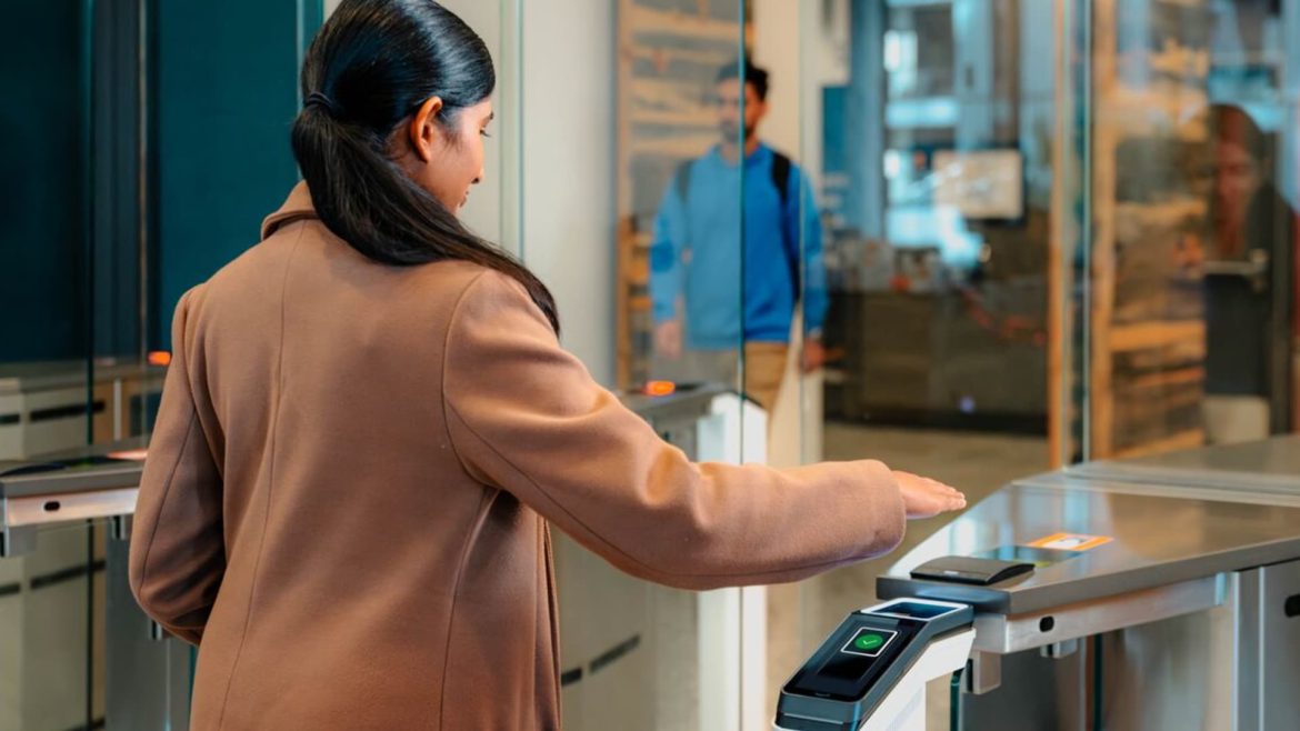 107339646-1701128126052-LI_Post-Amazon-One-Enterprise_AOE_Woman-Entering-Office_Medium-Shot-Behind-customer_hovering-palm.jpg